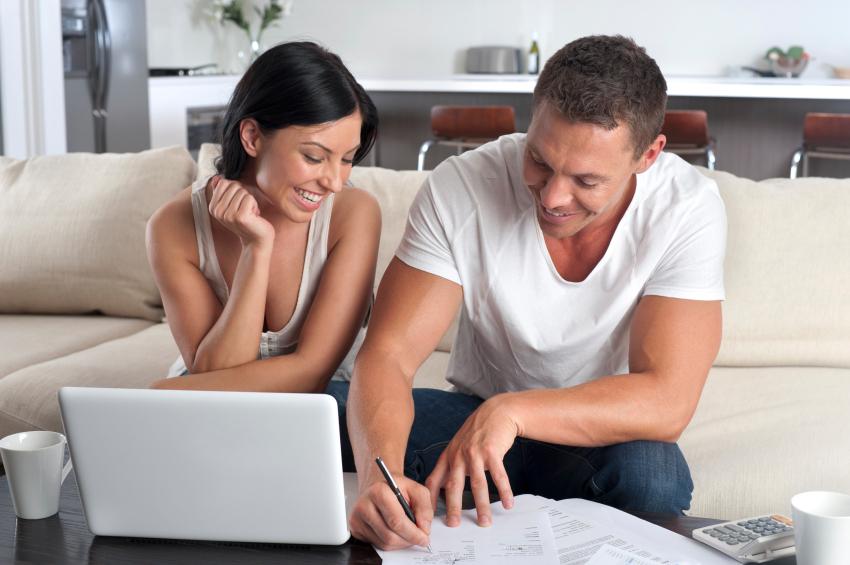 couple doing paperwork with a laptop